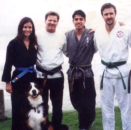 Happy faces. Courteney Cox and her husband wear KI Karate uniforms & belts